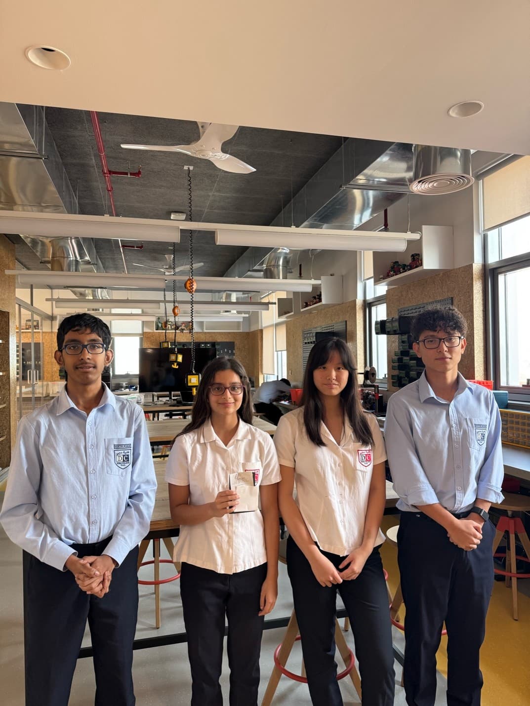 Students collaborating at a Dubai CS Society hackathon