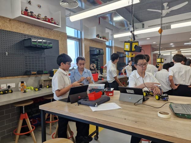 Students building robots at a Dubai CS Society workshop